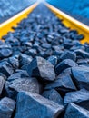 Close-up of coal rocks on train tracks with yellow rail Royalty Free Stock Photo