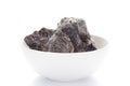 Close-up of coarse Himalayan Black Salt sodium chloride edible on white ceramic bowl.