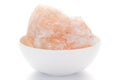 Close-up of coarse Himalayan Pink Salt sodium chloride edible on white ceramic bowl. Royalty Free Stock Photo