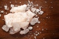 Close-up of coarse Himalayan Pink Salt sodium chloride edible on wooden top background.