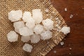 Close-up of coarse sea Salt sodium chloride edible on the wooden top background and jute mat.