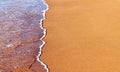 Close-up of the coast, clear sea water washes the sand shore Royalty Free Stock Photo