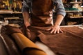 Close up of a cobbler working with leather textile