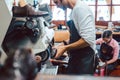Close-up of cobbler working on pair of shoes with machine Royalty Free Stock Photo