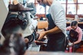 Close-up of cobbler working on pair of shoes with machine