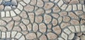 A close-up of a cobblestone-style paving. Earthy stones are set in concrete, creating a rustic, durable pattern Royalty Free Stock Photo