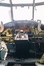 A close up of the cockpit of a vintage airplane. The steering wheel, dashboard, seat and climb levers are visible. Decommissioned