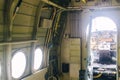 A close up of the cockpit of a vintage airplane. The steering wheel, dashboard, seat and climb levers are visible. Decommissioned