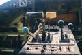 A close up of the cockpit of a vintage airplane. The steering wheel, dashboard, seat and climb levers are visible. Decommissioned