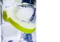 Close-up of cocktail glass with ice and lime slice isolated and space for text Royalty Free Stock Photo