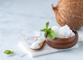 Close up of coconut MTC oil or medium chain triglycerides and coconut oil in a wooden bowl.