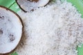 Close up of a coconut and a pile of shredded coconut