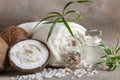 Close-up of Coconut, soft towels, coconut essence, sea salt, shells and tropical greens. Spa concept, beauty and health salon,