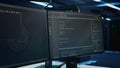 Close up of code running on computer screens in modern server room