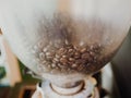 Close up of coffeen beans in the machine. Royalty Free Stock Photo