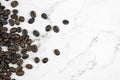 Close up coffee beans on a marble pattern background With copy space. Top view Royalty Free Stock Photo