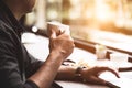 Close up of coffee cup on businessman hand. Man working with laptop computer. Business and Technology concept. Workaholics and