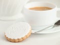 Close up of coffee cup and fondant covered cookie. Happy birthday decoration on top. Royalty Free Stock Photo