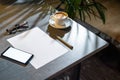 Close up of coffee cup ,glasses, paper, pen and mobile phone with blank screen. Royalty Free Stock Photo