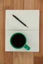 Close-up of coffee mug with diary and pen Royalty Free Stock Photo