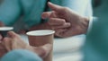 Close up of coffee on the table and businessman`s hands. A man drinking coffee at a meeting with customers. Pleasant Royalty Free Stock Photo