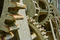 Close-up of the cogwheels of a historical weir of a river to regulate the spear wall of the weir