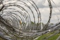 Razor wire on prison yard fence Royalty Free Stock Photo