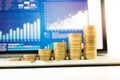 Close up coin stacked growing on financial graph chart in laptop Royalty Free Stock Photo