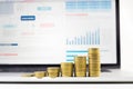 Close up coin stacked growing on financial graph chart in laptop Royalty Free Stock Photo