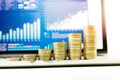 Close up coin stacked growing on financial graph chart in laptop Royalty Free Stock Photo