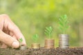 Close-up of coins, male hands stacking coins against green bokeh background finance and money business concept Save money to Royalty Free Stock Photo