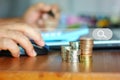 Close up coins stack while hand using computer mouse searching money rate , money concept Royalty Free Stock Photo