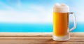 Cold mug of beer on a wooden table on background of the sea Royalty Free Stock Photo