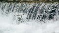 Close up of a cold stream of fresh water from mountain river, rapids, whitewater