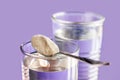 Close up collagen spoon and glass water lavender color background. Sustainability, beauty and healthy living concept