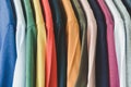 Close up collection of colorful t-shirts hanging on clothes hanger in closet or clothing rack Royalty Free Stock Photo