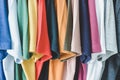 Close up collection of colorful t-shirts hanging on clothes hanger in closet or clothing rack Royalty Free Stock Photo