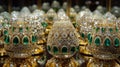 A close-up of a collection of dazzling gold and emerald green items, reminiscent of encrusted Easter eggs