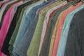 Close up a collection of pastel color t-shirts hanging on a wooden clothes hanger in closet or clothing rack over white Royalty Free Stock Photo