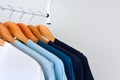 Collection shade of blue tone color t-shirts hanging on wooden clothes hanger in closet Royalty Free Stock Photo