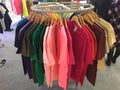 Close up on color coordinated clothes on hangers in a store. All colors clothes hanging on a rack nicely arranged. Royalty Free Stock Photo