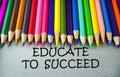 Close up colored pencil writing with EDUCATE TO SUCCEED .Education concept