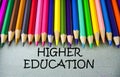 Close up colored pencil writing with HIGHER EDUCATION.Education concept