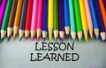 Close up colored pencil writing with LESSON LEARNED.Education concept