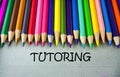 Close up colored pencil writing with TUTORING.Education concept