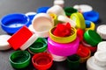 Close-up of colored PET caps on a black background. Recycled plastic bottle caps. Separate garbage collection. Recycling of Royalty Free Stock Photo