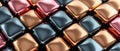 A close up of a colorful array of shiny, metallic cubes