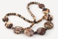 Close-up colorful beads from fossil jasper on white background