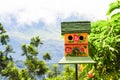 Close up of a colorful bird house in a garden Royalty Free Stock Photo