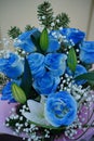 Close up of colorful bouquet of flowers. Flower composition of blue roses and white lilies in wrapping paper Royalty Free Stock Photo